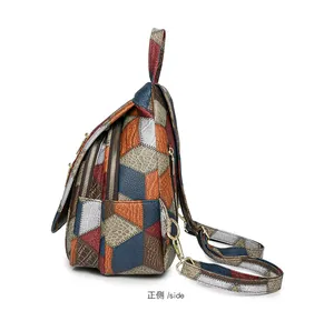 Detail view of multi-color crocodile pattern leather sling bag with gold zippers