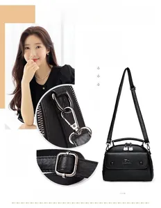 Detail view of black pebble leather doctor bag with adjustable strap and silver hardware