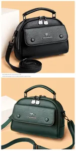 Detailed close-up of premium lychee grain leather bags in black and dark green shades