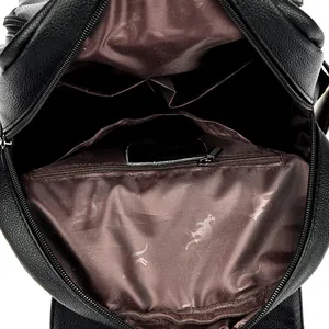 Spacious interior of black leather backpack showing multiple pockets and lining