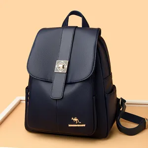 Deep blue leather backpack for women with kangaroo logo and gold buckle on orange background