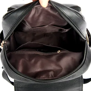 Black pebbled leather backpack showing spacious interior with pockets and gold hardware