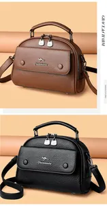 Close-up of litchi textured cowhide leather bags with dual metal zippers and kangaroo logo
