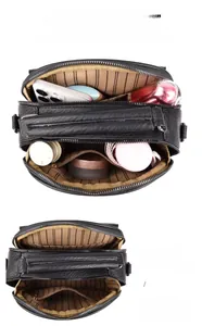 Detail of black leather bag interior showing multiple compartments and large capacity