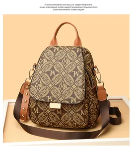 Detail of vintage patterned backpack with leather texture and gold-tone metal clasp