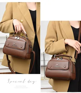 Detail of classic brown leather doctor bag with kangaroo logo and fine lychee texture