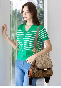 Detail view of vintage monogram backpack with metallic buckle and stud accents