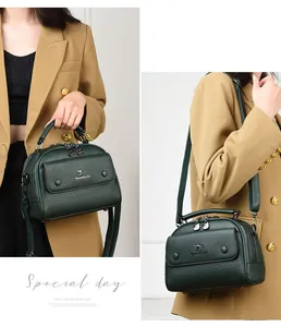 Detailed view of dark green leather doctor bag featuring pebble texture and kangaroo logo