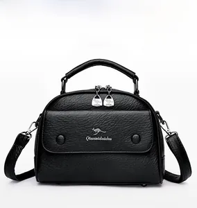 Front view of black pebble grain doctor bag with gold kangaroo emblem and top handle