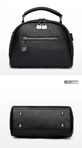 Close-up of black leather doctor bag showing rear zipper pocket and metal protective feet