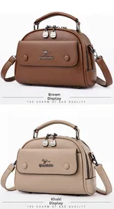 Detail of brown and khaki lychee pattern leather bags with round metal handles