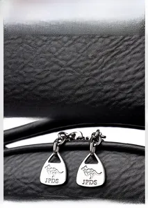 Detailed close-up of premium black lychee grain leather and engraved metallic zipper pull