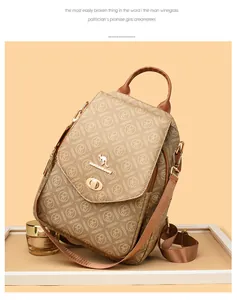 Detail of a brown patterned PVC backpack featuring a gold kangaroo logo and turn-lock closure