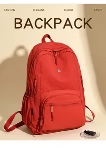 Close-up of red waterproof sports backpack showing durable texture and multi-pocket details