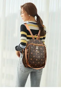 Close-up of brown vintage lattice backpack with kangaroo metal logo and clover pattern