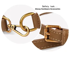 Detail of brown leather strap with glossy vintage gold metal hooks and buckle
