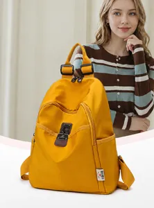 Close-up of a yellow nylon backpack featuring a front zipper pocket and side water bottle holder