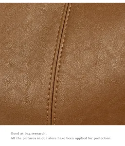 Close-up of caramel brown leather texture with precise double-stitching details