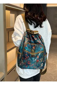 Detailed view of the vintage floral canvas backpack with a bronze metallic lock buckle