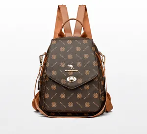 Detail view of the clover pattern print, gold kangaroo logo, and metal twist lock on a brown bag