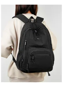 Detailed view of black waterproof nylon backpack featuring multiple functional zipper pockets
