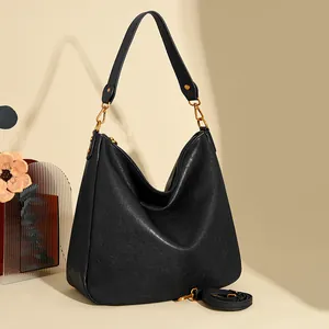 Large black pebbled leather hobo shoulder bag with gold hardware and crossbody strap