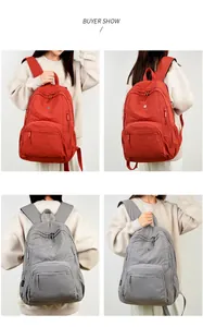 Front and back views of large waterproof nylon backpacks in burgundy and grey colors