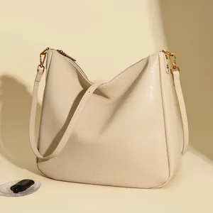 Chic cream leather hobo bag with large capacity and adjustable shoulder strap for women