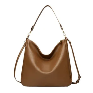 Brown soft leather tote bag with wide shoulder strap and large capacity commute style