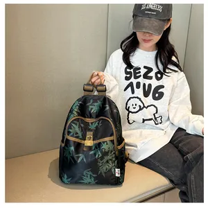 Detail of floral bamboo print backpack featuring metal buckle closure and nylon texture