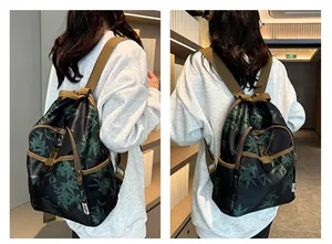 Lifestyle shot showing a printed backpack with bamboo leaf patterns and brown straps