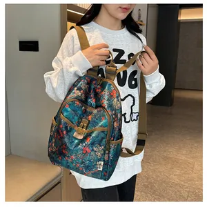 Detailed view of floral canvas backpack with vintage print and secure metal buckle closure