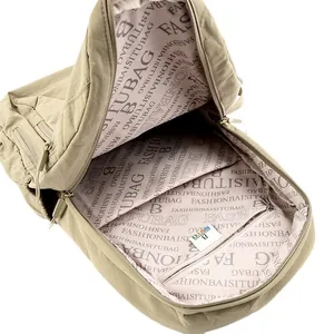 Spacious interior of khaki nylon backpack featuring multiple pockets and letter print lining