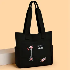 Borsa tote in tela nera con ricamo floreale rosa e uccelli con doppi manici lunghi