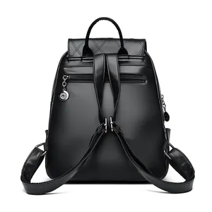 Black quilted leather backpack with silver chains, tassel details and star rhinestones