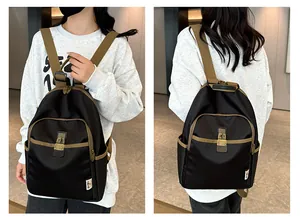 Detail view of contrast color backpack with metal buckle closure and multiple pockets
