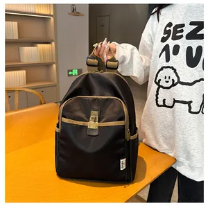 Detail of black backpack featuring khaki trim and vintage metal buckle in a library setting
