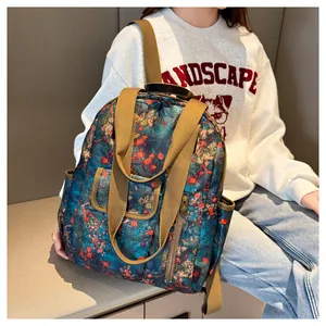 Detail of floral vintage backpack showing side pocket and waterproof pattern material