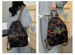 Detailed view of canvas backpack with floral print and vintage metal lock closure