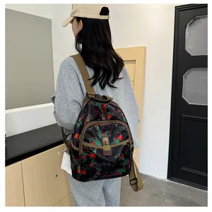 Close-up of vintage floral print backpack with adjustable brown straps and secure pockets
