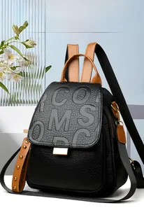 Macro detail of black litchi grain leather texture and oversized embossed logo design