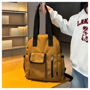 Detail of ginger canvas backpack with golden buckle flap and vertical zip pocket