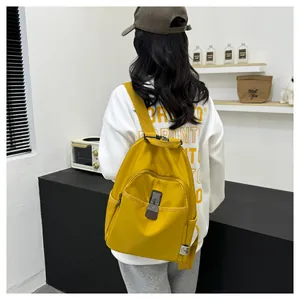 Back view of a vibrant yellow waterproof nylon backpack with secure metal buckles