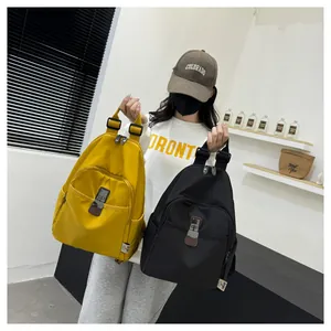 Detail view of yellow and black waterproof nylon backpacks with buckle front pockets
