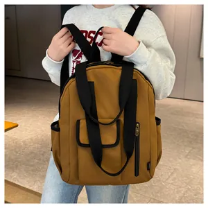Close-up of brown waterproof backpack with adjustable straps and side mesh pocket