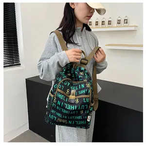 Detail of printed backpack with LUYIHELIN letters and brown adjustable shoulder strap