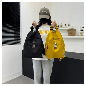 Detail view of water-resistant nylon backpacks in black and yellow with front buckle pockets