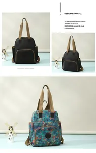 Detail of stylish canvas backpacks in solid black and floral prints with dual handles
