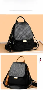 Detail of punk rivet backpacks with crocodile texture and embossed letters on orange background