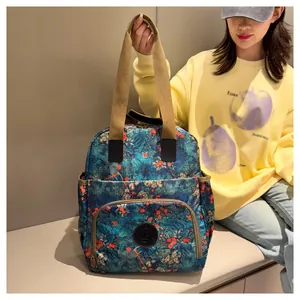 Detail of floral printed canvas backpack with dual handles and spacious front pocket